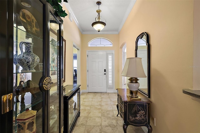 foyer entrance featuring ornamental molding