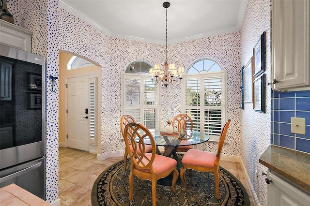 tiled dining space with a notable chandelier and crown molding