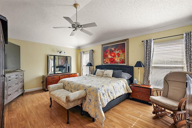 bedroom with crown molding, ceiling fan, a textured ceiling, and light wood-type flooring