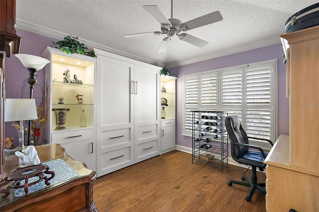 office area featuring ornamental molding, dark hardwood / wood-style floors, ceiling fan, and a textured ceiling