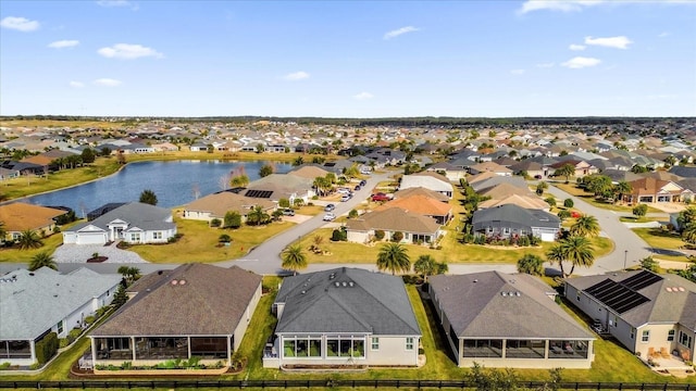 birds eye view of property with a water view and a residential view