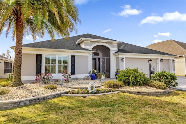 ranch-style home featuring a front yard, an attached garage, and stucco siding