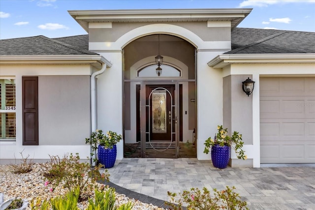 view of exterior entry featuring a garage