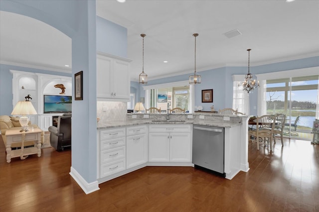 kitchen with light stone counters, white cabinets, a sink, and stainless steel dishwasher