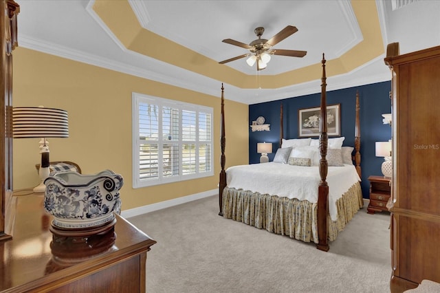 bedroom featuring baseboards, a raised ceiling, crown molding, and light colored carpet