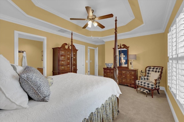 carpeted bedroom with crown molding, ceiling fan, and a tray ceiling