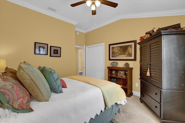 bedroom with lofted ceiling, ornamental molding, light colored carpet, ceiling fan, and a closet