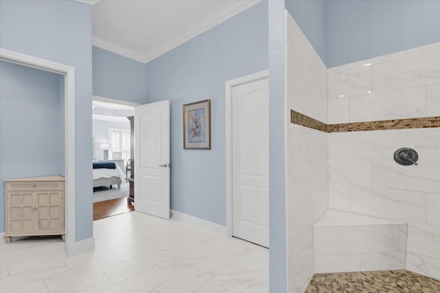 bathroom featuring a tile shower and crown molding