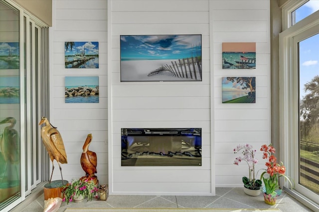 interior details featuring a glass covered fireplace