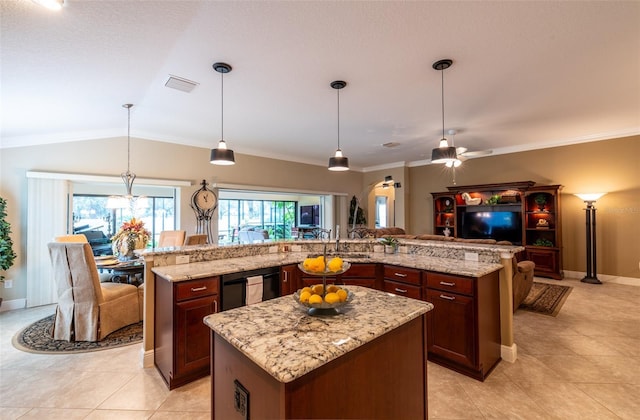 kitchen with lofted ceiling, light stone counters, hanging light fixtures, ornamental molding, and a large island