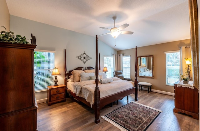 bedroom featuring dark hardwood / wood-style flooring, lofted ceiling, and ceiling fan