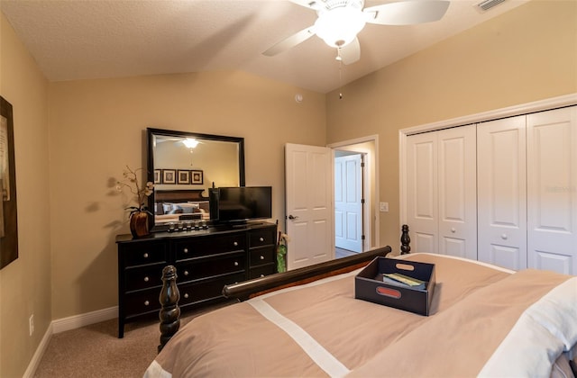 bedroom featuring ceiling fan, carpet flooring, vaulted ceiling, and a closet