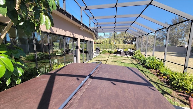 view of patio / terrace featuring an outdoor living space and glass enclosure