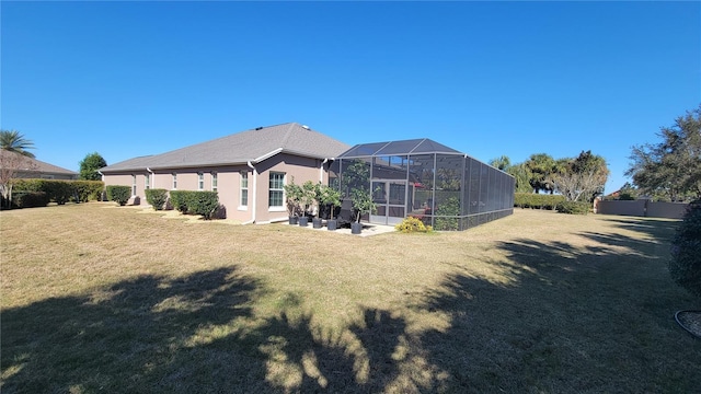 back of property featuring a yard, a lanai, and a patio