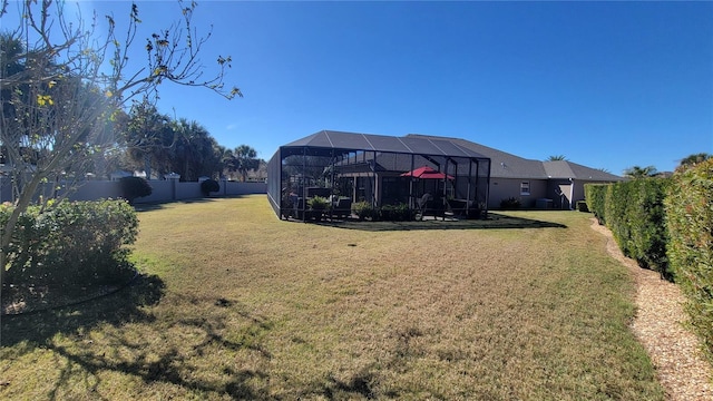 view of yard with glass enclosure