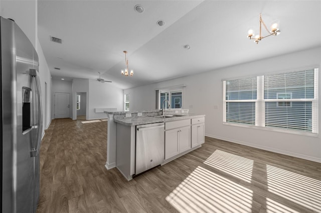 kitchen featuring pendant lighting, sink, white cabinets, a kitchen island with sink, and stainless steel appliances