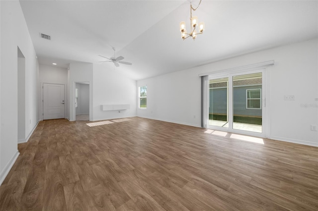 unfurnished living room featuring ceiling fan with notable chandelier, dark wood-type flooring, and vaulted ceiling