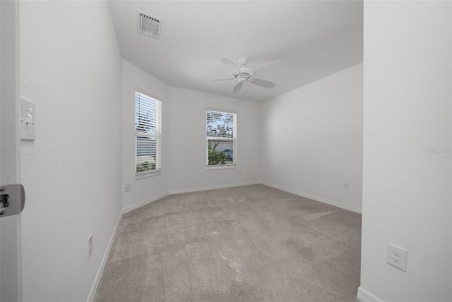 spare room with light colored carpet and ceiling fan