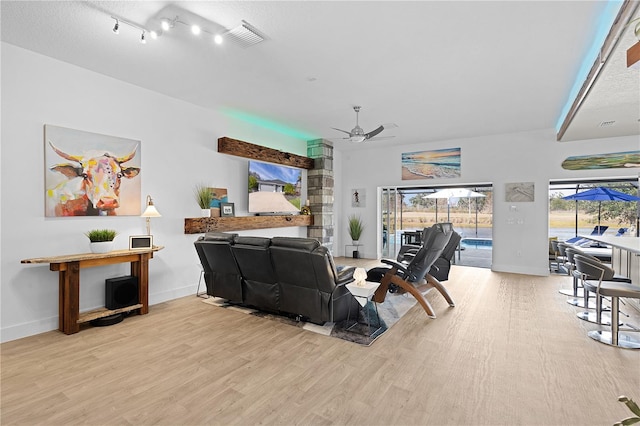 living room featuring ceiling fan and light wood-type flooring