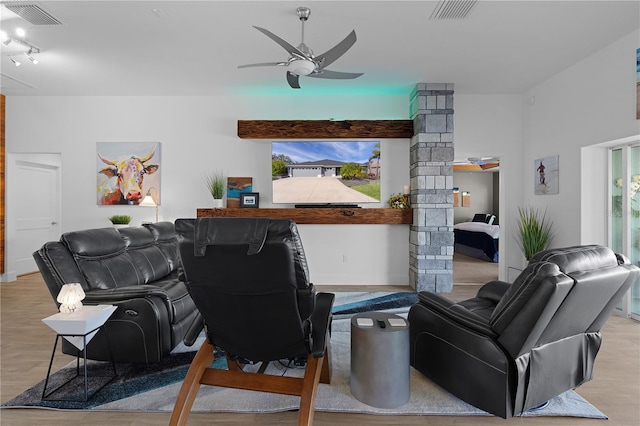 living room featuring light hardwood / wood-style flooring, decorative columns, and ceiling fan