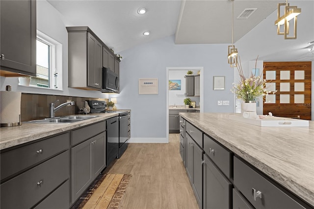 kitchen featuring sink, gray cabinets, hanging light fixtures, light hardwood / wood-style floors, and black appliances