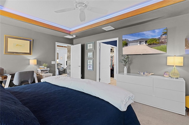 bedroom with visible vents, a ceiling fan, light colored carpet, a spacious closet, and a closet