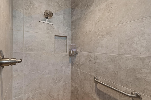 interior details with a tile shower