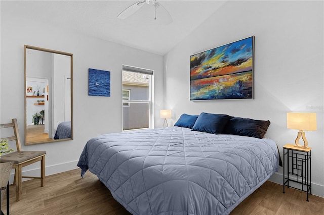 bedroom with vaulted ceiling, hardwood / wood-style floors, and ceiling fan