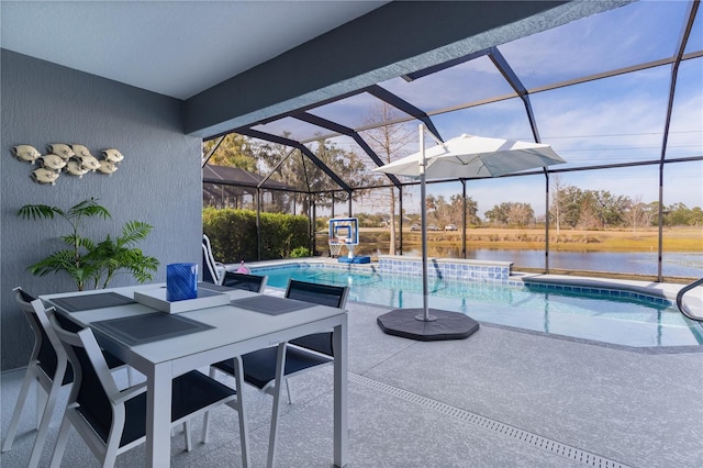 view of swimming pool with a patio, glass enclosure, and a water view