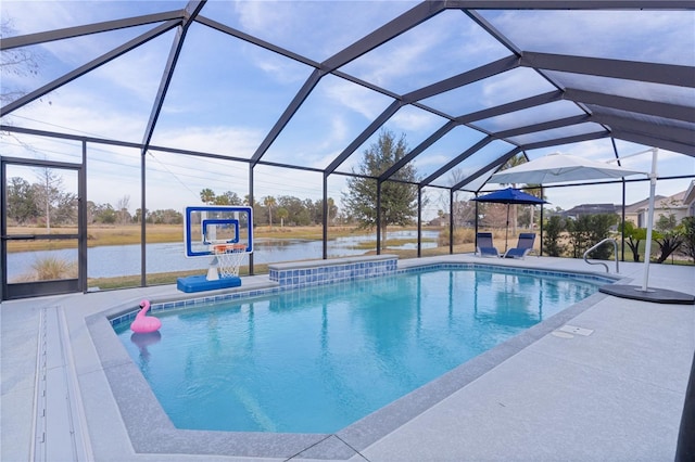 view of swimming pool with a patio area, a water view, and glass enclosure