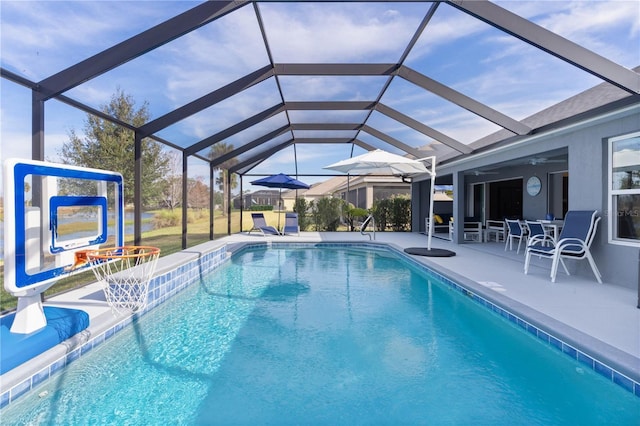 view of swimming pool featuring a lanai and a patio area