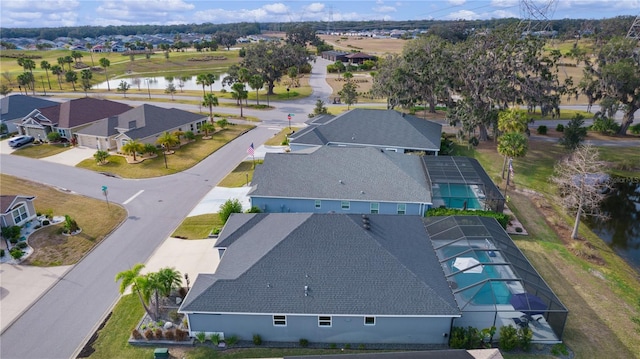 drone / aerial view with a residential view and a water view