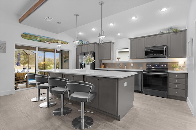 kitchen featuring gray cabinetry, stainless steel microwave, visible vents, and black / electric stove