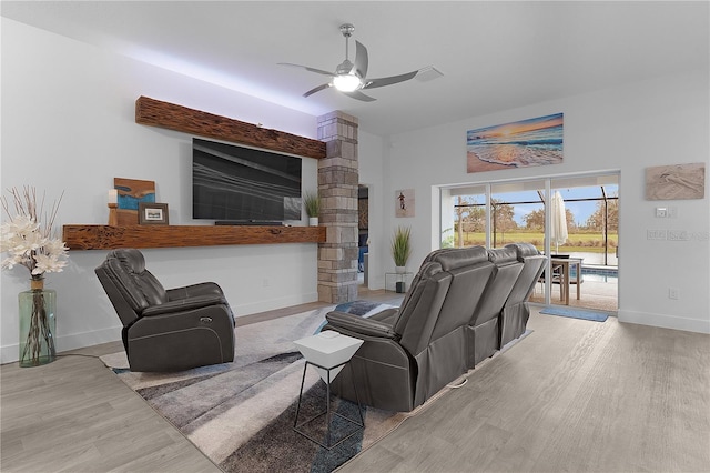 living area with ceiling fan, wood finished floors, and baseboards