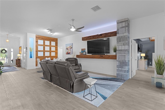 living area with visible vents, baseboards, a ceiling fan, wood finished floors, and ornate columns