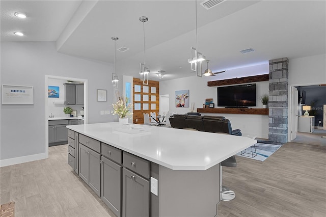 kitchen featuring light countertops, light wood-style floors, visible vents, and gray cabinetry