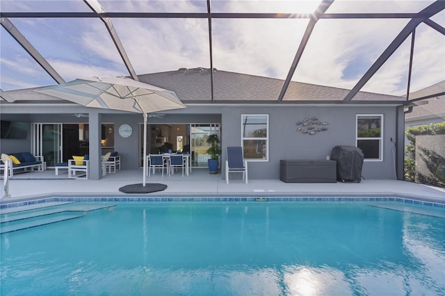 pool featuring glass enclosure, a grill, and a patio