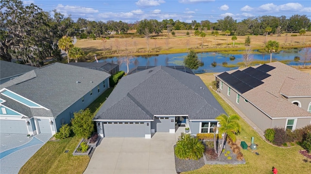 birds eye view of property with a water view