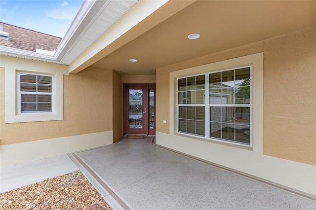 view of exterior entry featuring a patio area