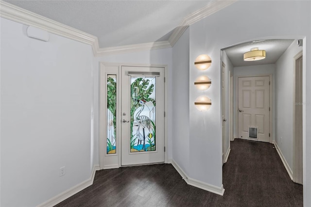 foyer entrance featuring ornamental molding and a textured ceiling