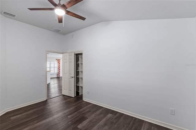 spare room with vaulted ceiling, ceiling fan, and dark wood-type flooring