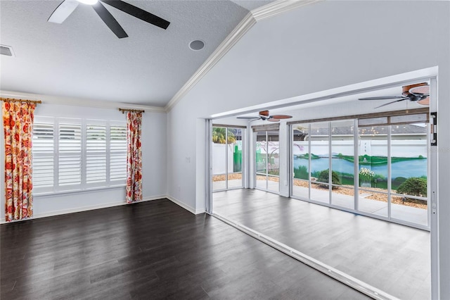 unfurnished living room featuring a textured ceiling, a wealth of natural light, ornamental molding, and vaulted ceiling