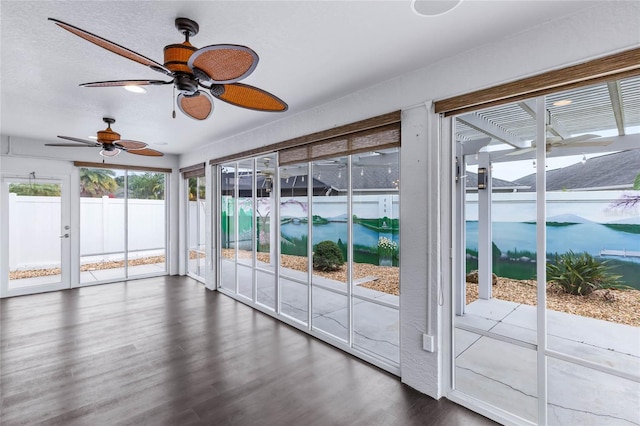 interior space featuring ceiling fan and a water view