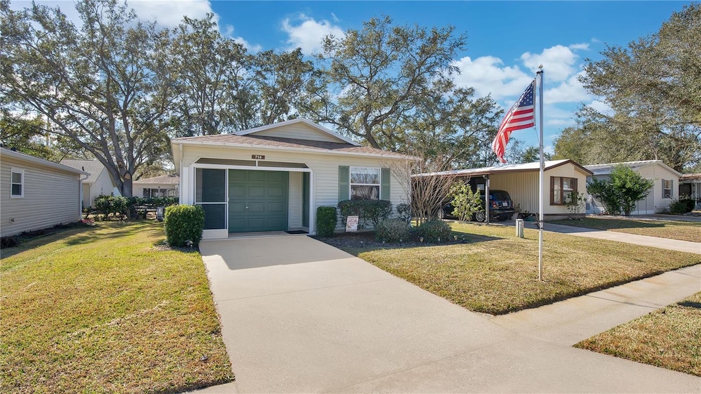 single story home featuring a carport, a garage, and a front lawn