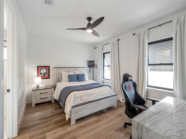 bedroom with hardwood / wood-style floors and ceiling fan