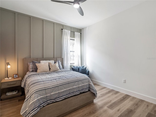 bedroom with light hardwood / wood-style flooring and ceiling fan