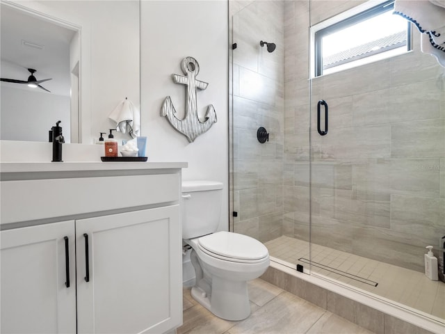 bathroom with vanity, a shower with shower door, and toilet