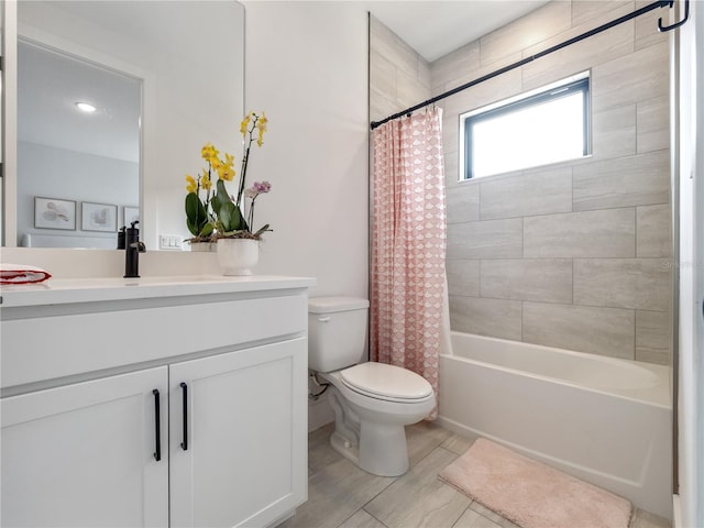 full bathroom featuring vanity, shower / tub combo with curtain, and toilet