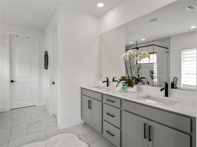 bathroom featuring vanity and a shower with door