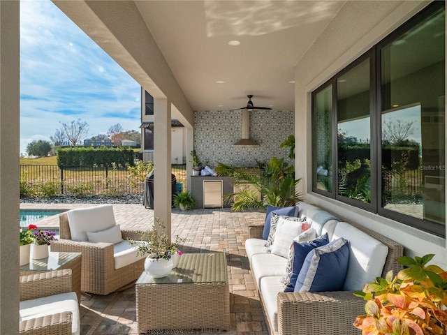 view of patio with a fenced in pool, an outdoor hangout area, and ceiling fan